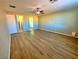 Spacious bedroom featuring wood-look floors, a ceiling fan, and neutral paint at 1630 Meadow Bluffs Ave, Henderson, NV 89014