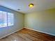 Bedroom featuring hardwood floors and a window with blinds at 1630 Meadow Bluffs Ave, Henderson, NV 89014