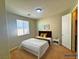 Charming bedroom with carpet, highlighted by a window, closet, and nightstand, offers a tranquil and organized space at 1630 Meadow Bluffs Ave, Henderson, NV 89014