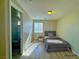 Comfortable bedroom featuring bright natural light, wood flooring, and an adjoining bathroom at 1630 Meadow Bluffs Ave, Henderson, NV 89014