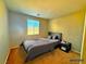 Well-lit bedroom featuring carpet, a window, and ample space, providing a cozy and inviting atmosphere at 1630 Meadow Bluffs Ave, Henderson, NV 89014