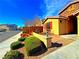 Charming home features a colorful exterior, neat landscaping, and a brick walkway at 1630 Meadow Bluffs Ave, Henderson, NV 89014