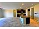 Open-concept kitchen with granite island and stainless steel appliances at 1630 Meadow Bluffs Ave, Henderson, NV 89014