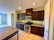 Well-equipped kitchen featuring dark wood cabinetry, stainless steel appliances, and granite countertops at 1630 Meadow Bluffs Ave, Henderson, NV 89014