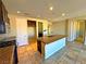 Open kitchen showcases a granite island, stainless steel appliances, and tile floors at 1630 Meadow Bluffs Ave, Henderson, NV 89014