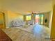 Bright living room featuring tile floors, a ceiling fan, and comfortable seating, creating a welcoming and relaxing atmosphere at 1630 Meadow Bluffs Ave, Henderson, NV 89014