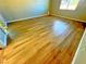 Spacious room features wood floors, neutral walls, and natural light from windows at 1630 Meadow Bluffs Ave, Henderson, NV 89014