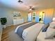 Spacious main bedroom boasts wood floors, a ceiling fan, and an en-suite bathroom for comfort and convenience at 1630 Meadow Bluffs Ave, Henderson, NV 89014