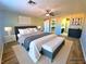 Well-lit main bedroom featuring a king-sized bed, carpet flooring, and access to the closet and bathroom at 1630 Meadow Bluffs Ave, Henderson, NV 89014
