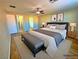 Inviting main bedroom features a ceiling fan, wood floors, and an attached bathroom, creating a private retreat at 1630 Meadow Bluffs Ave, Henderson, NV 89014