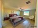 Bright and airy main bedroom with wood flooring, a ceiling fan, and modern decor accents at 1630 Meadow Bluffs Ave, Henderson, NV 89014