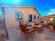 Outdoor patio area with comfortable seating, a fire pit coffee table, and a view of the backyard at 1630 Meadow Bluffs Ave, Henderson, NV 89014