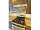 The kitchen features stainless steel appliances, granite countertops, and rich, dark wood cabinetry at 1630 Meadow Bluffs Ave, Henderson, NV 89014