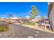 Backyard featuring gravel, artificial grass, shade trees and a wall for privacy at 258 Spring River Ave, Las Vegas, NV 89123