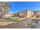 Spacious backyard features a patio, drought-tolerant landscaping, and a well-maintained perimeter wall at 258 Spring River Ave, Las Vegas, NV 89123