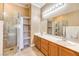 Modern bathroom features double sinks, walk-in shower, and open storage shelving at 258 Spring River Ave, Las Vegas, NV 89123