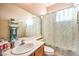 Bathroom featuring a spacious mirror, a vanity and sink, and a shower with a patterned curtain at 258 Spring River Ave, Las Vegas, NV 89123