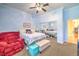 Cozy bedroom featuring soft blue walls, mirrored closet doors, and a comfortable sitting area at 258 Spring River Ave, Las Vegas, NV 89123