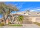 Charming single story home with mature tree, two-car garage, and manicured front lawn at 258 Spring River Ave, Las Vegas, NV 89123