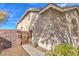 Exterior view of home with private gated courtyard and low maintenance desert landscaping at 258 Spring River Ave, Las Vegas, NV 89123