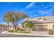 Single story home with a two-car garage, lush front lawn, and a corner lot at 258 Spring River Ave, Las Vegas, NV 89123