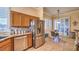 Well-lit eat-in kitchen featuring stainless appliances, breakfast nook and backyard access at 258 Spring River Ave, Las Vegas, NV 89123