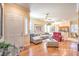 Sunlit living room featuring hardwood floors, neutral paint, and an open floor plan at 258 Spring River Ave, Las Vegas, NV 89123