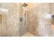 A luxurious shower with a rain showerhead and decorative tile is featured at 258 Spring River Ave, Las Vegas, NV 89123