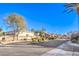 Scenic street view of a residential community with manicured landscaping on a clear, sunny day at 258 Spring River Ave, Las Vegas, NV 89123