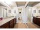 Bright bathroom featuring double sinks, granite countertops, mirrors, and a separate toilet room at 2606 S Durango Dr # 152, Las Vegas, NV 89117