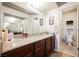 A well-lit bathroom featuring a granite countertop, dark wood cabinets, and a separate toilet room at 2606 S Durango Dr # 152, Las Vegas, NV 89117