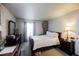 Bedroom featuring two windows, a bed, and dark furniture at 2606 S Durango Dr # 152, Las Vegas, NV 89117