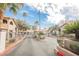 Inviting gated community entrance with palm trees and an American flag at 2606 S Durango Dr # 152, Las Vegas, NV 89117