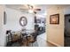 Open-concept dining area with a round glass table and seating for four at 2606 S Durango Dr # 152, Las Vegas, NV 89117