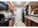 Efficient kitchen with essential appliances, dark cabinets, laminate countertops and ample counter space at 2606 S Durango Dr # 152, Las Vegas, NV 89117