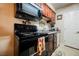 Compact kitchen with essential appliances, laminate countertops, and dark cabinetry for efficient meal preparation at 2606 S Durango Dr # 152, Las Vegas, NV 89117