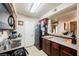 Functional kitchen with essential appliances, dark cabinets, laminate countertops and an adjacent dining area at 2606 S Durango Dr # 152, Las Vegas, NV 89117