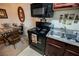 Efficient kitchen featuring a black oven, microwave, and stainless steel sink at 2606 S Durango Dr # 152, Las Vegas, NV 89117