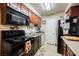 Functional kitchen with essential appliances, laminate countertops, and plenty of storage in the dark cabinetry at 2606 S Durango Dr # 152, Las Vegas, NV 89117