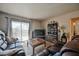 Bright living room featuring a sliding door, sleek entertainment center, and cozy sofas perfect for relaxing at 2606 S Durango Dr # 152, Las Vegas, NV 89117