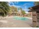 Community pool area surrounded by lush landscaping and seating for residents at 2606 S Durango Dr # 152, Las Vegas, NV 89117