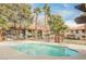 Community pool area surrounded by lush landscaping and seating for residents at 2606 S Durango Dr # 152, Las Vegas, NV 89117