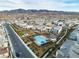 An aerial view of a Primary-planned community featuring a pool, landscaping, and mountain views at 2699 Chance Canyon St, Henderson, NV 89044