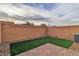 Cozy backyard with artificial turf, brick pavers, and secure brick wall offering privacy at 2699 Chance Canyon St, Henderson, NV 89044