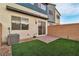 Back exterior with small patio featuring artificial turf, perfect for entertaining at 2699 Chance Canyon St, Henderson, NV 89044