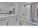 Bathroom featuring modern white cabinets, a toilet and a shower with a curtain at 2699 Chance Canyon St, Henderson, NV 89044