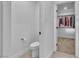 Bathroom featuring white toilet, neutral walls and a view into a well organized walk-in closet at 2699 Chance Canyon St, Henderson, NV 89044