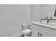 Modern half bathroom featuring a white vanity and elegant gold faucet at 2699 Chance Canyon St, Henderson, NV 89044