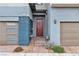 Modern townhouse entrance with a stylish door, two-car garage and landscaped walkway at 2699 Chance Canyon St, Henderson, NV 89044