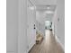 Bright hallway featuring wood floors, a staircase, and modern white doors at 2699 Chance Canyon St, Henderson, NV 89044